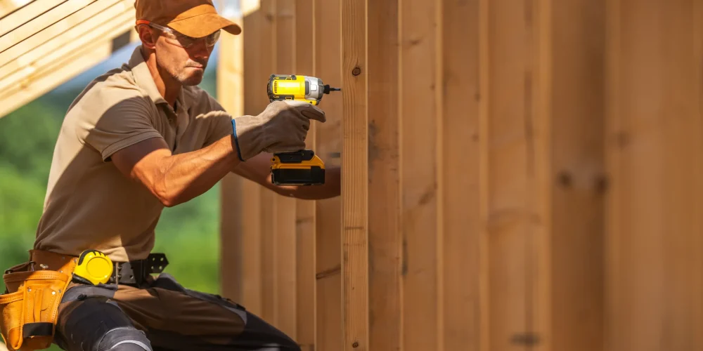 carpenter-using-a-power-drill-to-fasten-wooden-boa-2025-08-25-18-22-26-utc